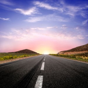 Image of a road heading off into a beautiful sunset